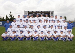 Baseball team in uniform lined up for a group photo. 