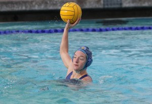 Kelly Stewart holds a waterpolo ball ready to throw. 