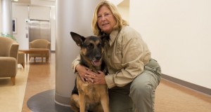 Woman posing with her K-9 canine partner. 