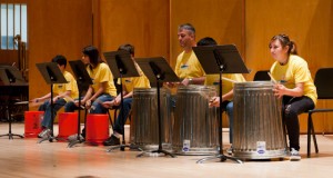 Recent SJSU graduate Joseph Reichert, center, and his percussion pupils perform the song "Funky Buckets" with metal garbage cans, plastic buckets and drumsticks at the Music Building Concert Hall on June 24. Photo by James W. Murray.