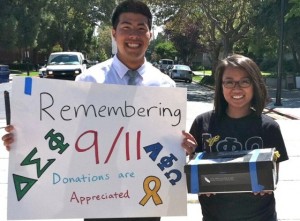 Young man and woman carrying a sign and collection box.
