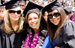 Three ethnically diverse female grads at commencement.