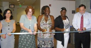 Students, a professor and the provost cut the ribbon on new offices.
