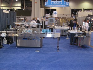 A filler machine at the Pack Expo in Las Vegas. Attendants are showing visitors how the bottles are filled on a packaging line