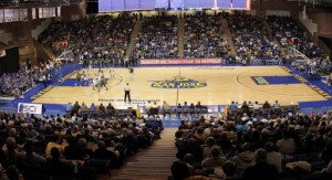 Picture of an SJSU basketball game being played at spartan stadium with a crowd of people watching in the audience. 
