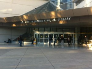Photo of the university side entrance of the Martin Luther King Library with students entering and exiting the building.
