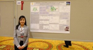 Ngoc standing in front of her poster.