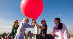 Students holding giant weather balloon atop Duncan Hall (David Schmitz photo).