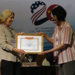Dr. Alice Hines, left, accepts an award for SJSU's work on enhancing social work education in Vietnam.