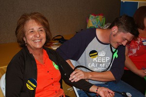 Jonathan Dinson, right, takes Leticia Medrano's blood pressure at the Senior Wellness Fair in 2014. Dinson, then a student in SJSU's Valley Foundation School of Nursing, is just one of dozens of students to volunteer at the wellness fairs in the last five years.
