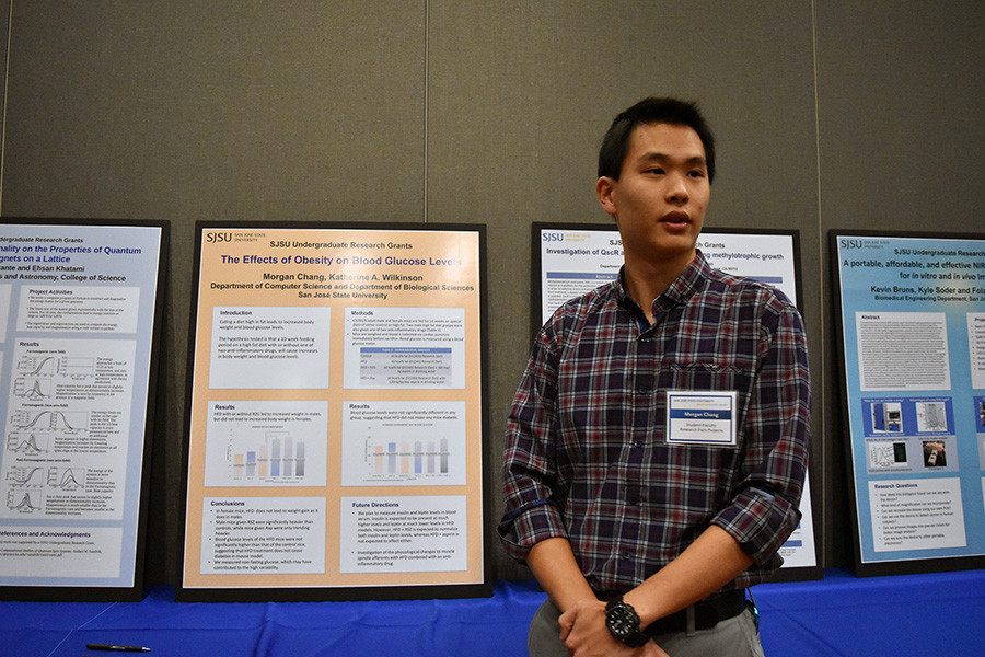 Morgan Change explains his research project to a faculty member at the Celebration of Research on Feb. 10.