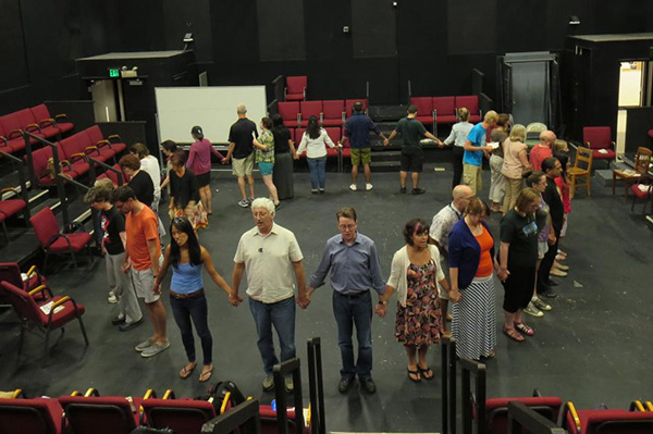 Photo courtesy of Matthew Spangler Dr. Matthew Spangler, center right in gray, and Dr. David Kahn, center left in white, lead participants of a 2014 summer institute, "The Immigrant Experience in California through Literature and Theatre" through a performance exercise. The pair will host the program this summer with a National Endowment for the Humanities grant.