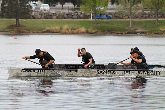 A team of SJSU students compete in a men's sprint race with their concrete canoe.