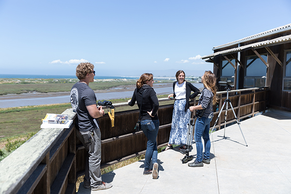 Visitors look at the view of Moss Landing.