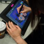 An SJSU student uses Adobe Creative Cloud products during a design competition on Feb. 24 in which students were challenged to illustrate their idea of "fake news." (Photo: James Tensuan, '15 Journalism)