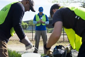 Students and alumni clean up Coyote Creek, which flooded in February. (Photo: James Tensuan, '15 Journalism)
