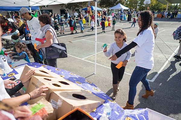 Kids learn about recycling with a can toss game. (Photo: James Tensuan, '15 Journalism)
