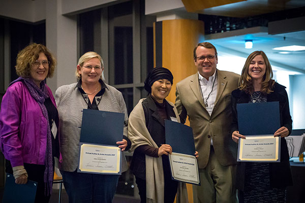 Provost Andy Feinstein, second from the right, poses with authors during a celebration Nov. 3.