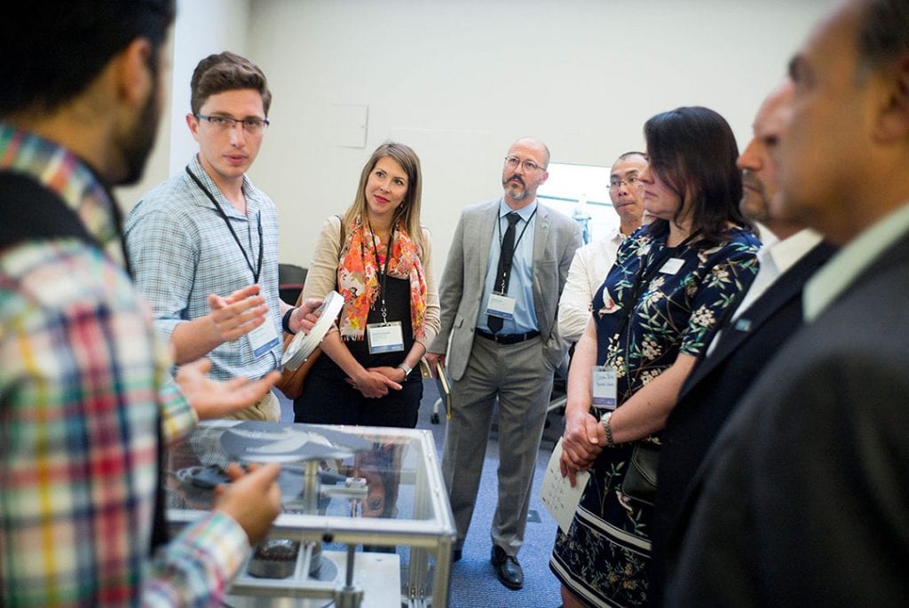 Academic leaders and industry partners talk with members of SJSU's Spartan Hyperloop team at the Innovation Design Collaborative at San Jose State on Friday, June, 8, 2018. (James Tensuan/San Jose State University)