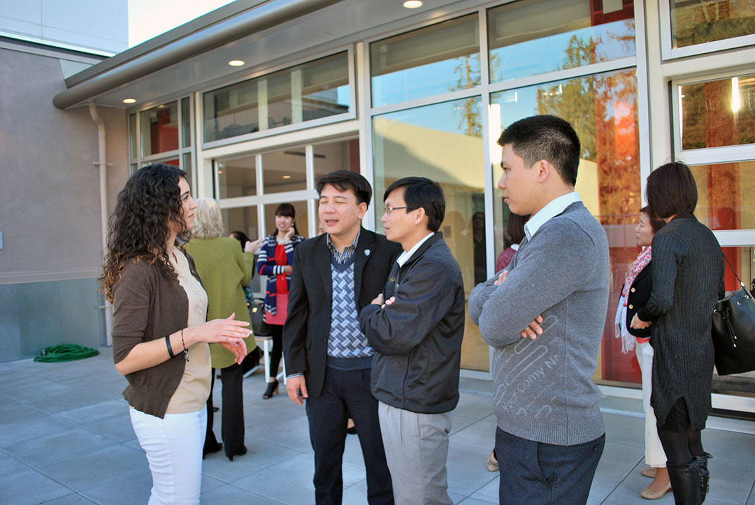 Social Work graduate student Veronica Cavillo talks with visitors from Vietnam at the Social Work Education Enhancement Project Fellows' reception March 4.