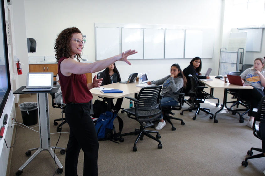 Ellen Middaugh teaching in a classroom pre-pandemic
