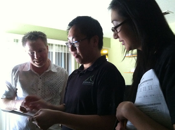 Environmental studies graduate student Anna Le and engineering graduate student Gordon Poon explain usage of electricity, natural gas and water on a utility bill to a San Jose resident.