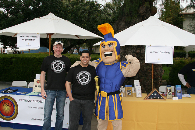 Student vets visit with Sammy the SJSU mascot outside their student activities fair both.