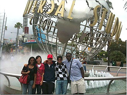 Students posing in front of iconic Universal Studios signage.
