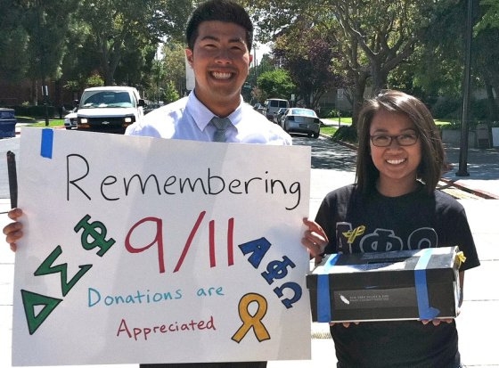 Young man and woman carrying a sign and collection box.