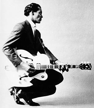 black and white photo of a young Chuck Berry and guitar
