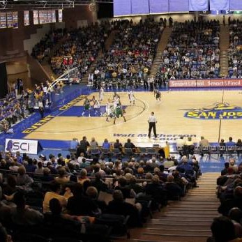 Picture of an SJSU basketball game being played at spartan stadium with a crowd of people watching in the audience.