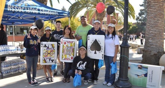 Group of students and employees, some wearing large playing cards, in celebration of the Poker Walk fitness event.