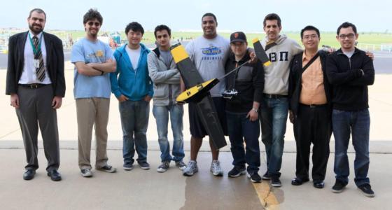 group shot of team with model airplane