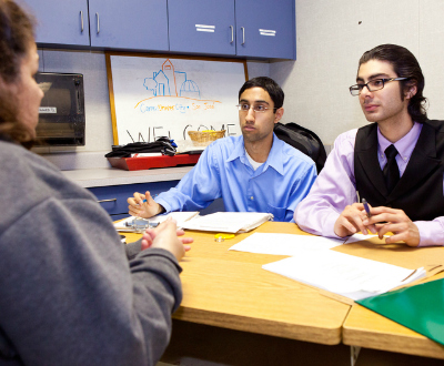 Students meeting with a client.
