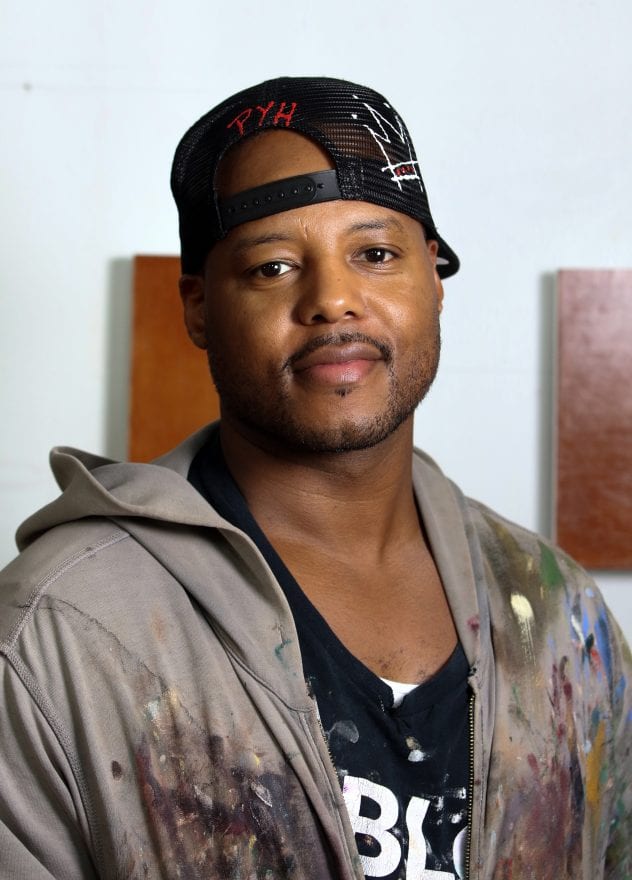 Titus Kaphar, '01 B.F.A., is a painter and sculptor who addresses the lack of representation of people of color in the history of Western art by appropriating Western art’s styles and mediums. Here he is pictured in his studio in New haven, CT. (Photo by John D. and Catherine T. MacArthur Foundation)