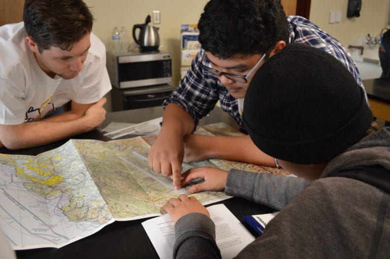 SJSU Aviation majors teach a prepared lesson on aviation navigation to a student in San José High School’s robotics club.