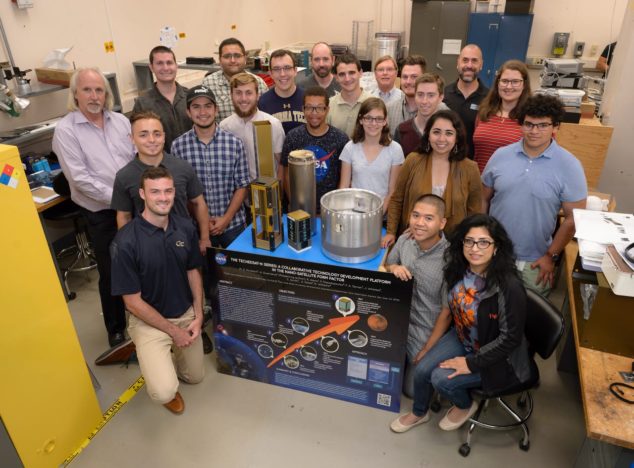 TechEdSat group in N-244 Lab 9 with mentors Mark Murbach (standing back left) and Ali Guarneros Luna (kneeling on right). Photo courtesy of NASA Ames Research Center.