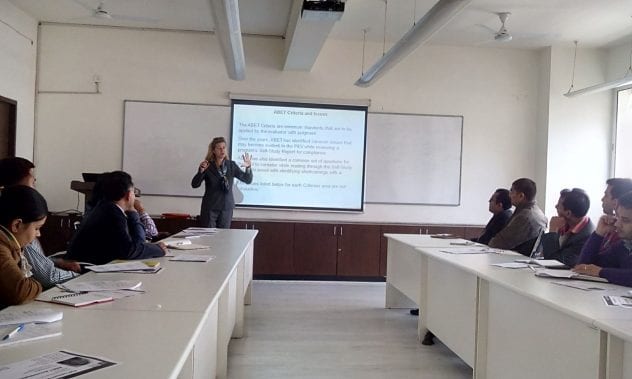 Claire Komives, in the center by the screen, offers training on using active learning techniques at the end of her last Fulbright Scholar year in 2014-15.