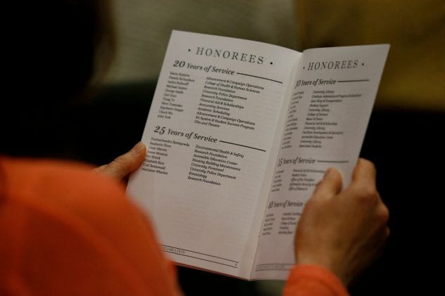 A guest looks through the program at the list of honorees. ( Josie Lepe/San Jose State University )