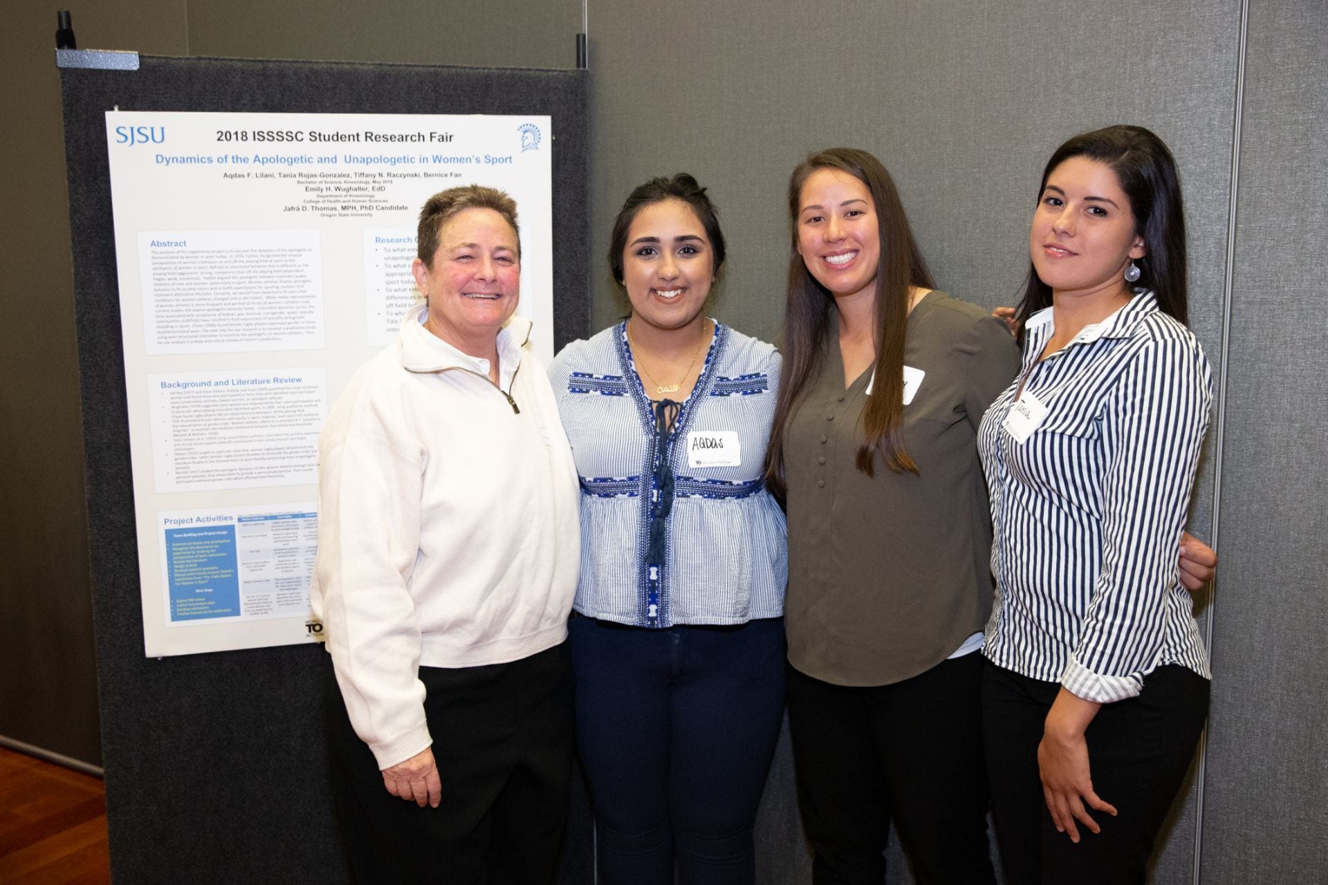 Professor Emily Wughalter, Aqdas Lilani, Tiffany Raczynski and Tania Rojas pose for a photo at the Institute for the Study of Sport, Society and Social Change Student Research Fair in 2018. Photo by David Schmitz 