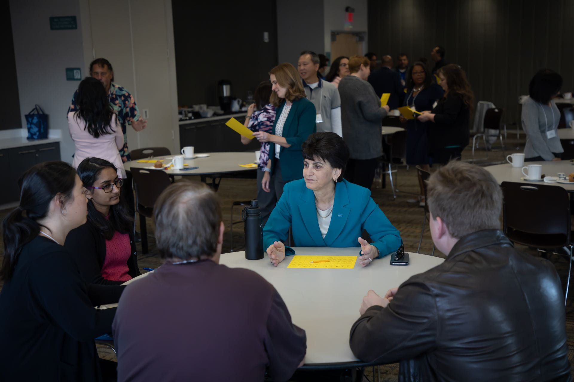 President Papazian talks with staff members at a "Coffee with the President" event.