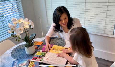 Lisa Millora and daughter reading together