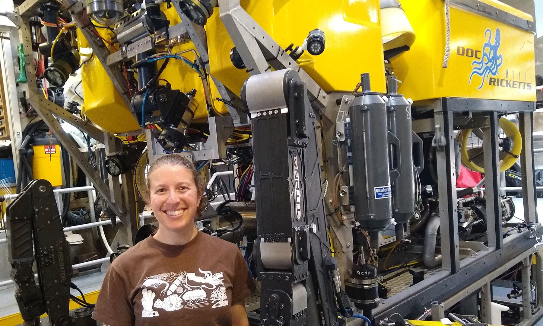 Amanda Kahn onboard MBARI's R/V Western Flyer in front of the remotely operated vehicle Doc Ricketts. Photo courtesy of Amanda Kahn/MBARI.