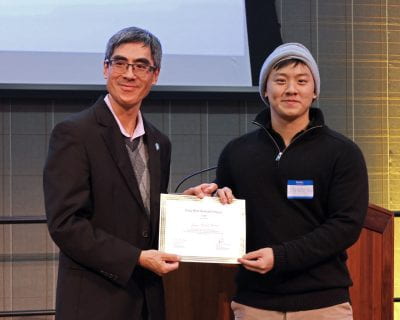 Alan Wong, Interim Associate Dean of the College of Professional and Global Education, presents Kai-Ren Hou ’23 BSBA Business Analytics with the Social Impact Innovation Award for his project Home Sweet Home.