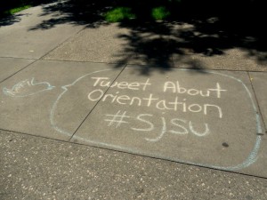 sidewalk chalk drawing of a bird with a cartoon bubble, "Tweet About Orientation #SJSU"